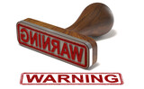 Rubber stamp with the word warning printed over white background