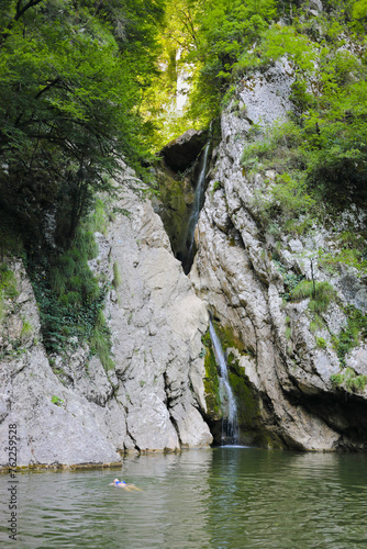 woman bathing in river Agura near waterfall Devils in Sochi, Krasnodar Krai, Russia