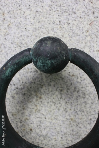 Ring door handle made of copper metal.