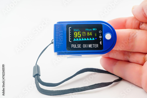 Medical pulse oximeter with an LCD. Heart and pulse rate, crucial in patient health monitoring, emergencies. SpO2, Assessment of blood oxygen saturation. Medical monitoring device pandemic COVID-19. photo