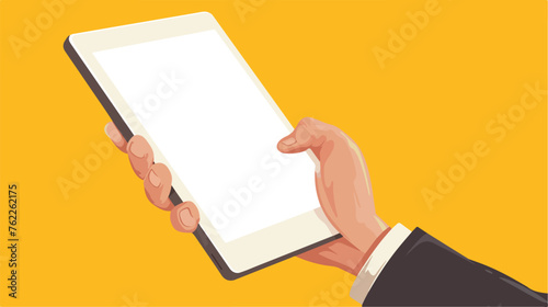 Hand holding and touching tablet on yellow background photo