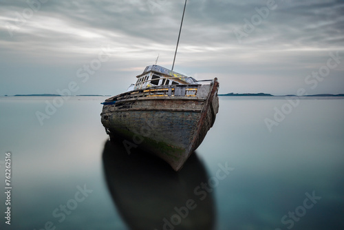 Abandoned boats at appledore in devon with water and mist added 