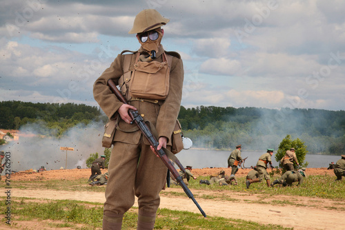 Collage with soldier with gun on background of attack in WWI military show photo