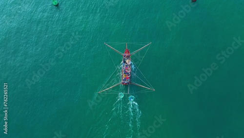 The fishing boat of Vietnamese fishermen is running on the sea in the morning during the trip to sea, aerial view. Travel and maritime background.