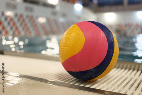 Ball for water polo in front of the pool, close-up photo