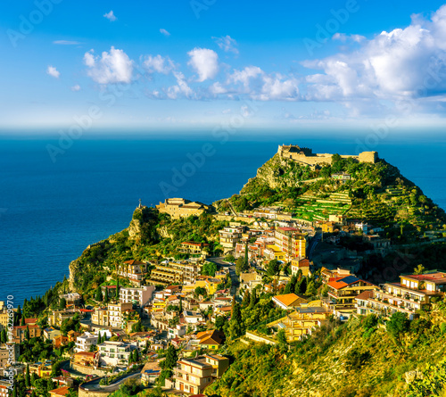 Fototapeta Naklejka Na Ścianę i Meble -  scenic view at beautiful mountain town on a sea coast in Italy with green hills, antique buildings and amazing blue sea on backgeound of landscape