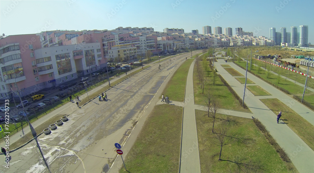 Cityscape with alley of Pilots Heroes at Hodynskoe field at spring sunny day, aerial view