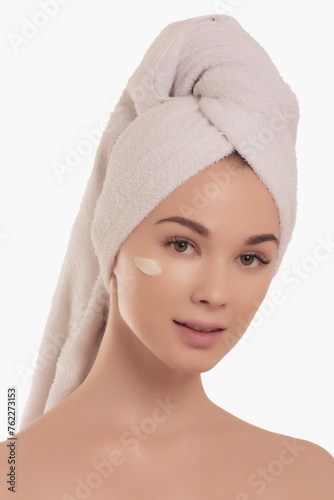 Beauty skin. Head and shoulders of blond woman model  touching glowing  hydrated facial skin  apply toner  skin cream or lotion for healthy look  after shower portrait  white background.