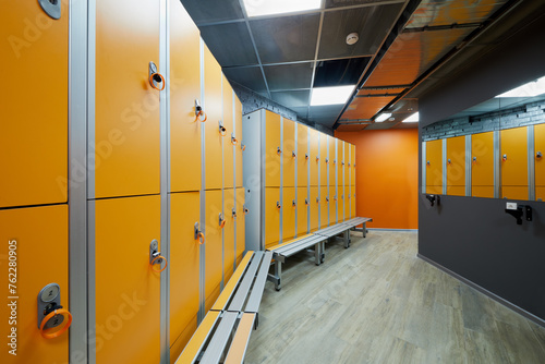 Room with orange lockers at fitness center. photo