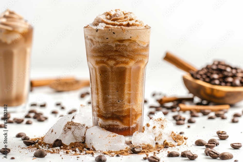 Coffee slush in tall glass with beans and crushed ice around it on white table with isolated background. Front view. Horizontal composition.
