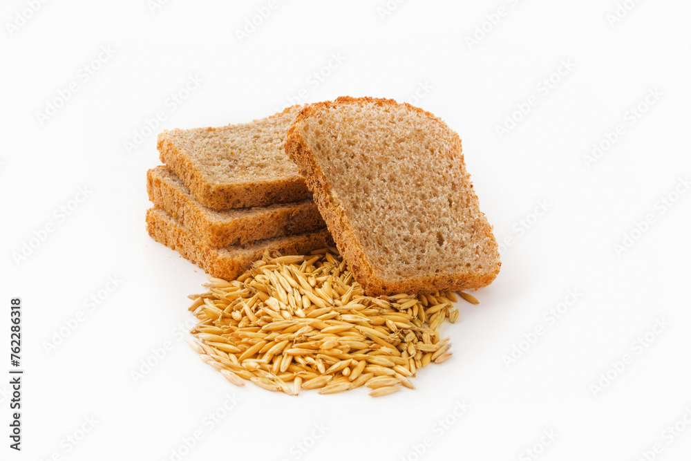 Slices of grain bread and wheat grains on a white isolated background. Healthy food concept Slices of grain bread and wheat grains on a white isolated background. Healthy food concept