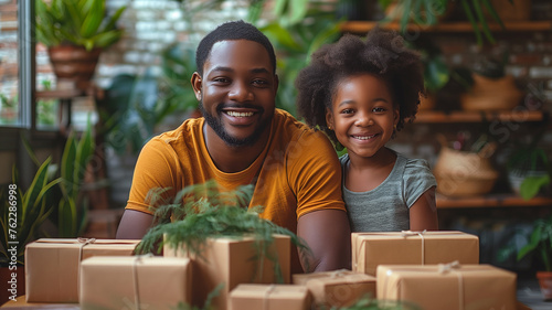 A man and a little girl are posing for a picture in front of a bunch of boxes © CtrlN