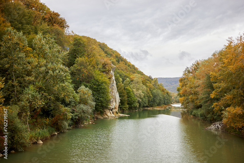 Trees and rock Petushok on riverside of river Psekups in Goryachiy Kluch, Krasnodar region, Russia. photo