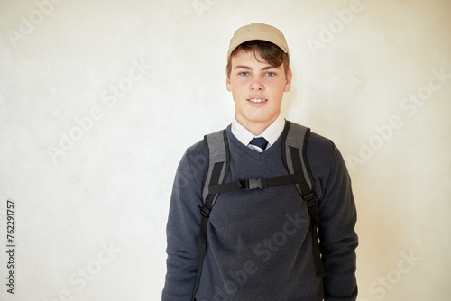Bild auf Leinwand Portrait of smiling schoolboy in cap with rucksack.