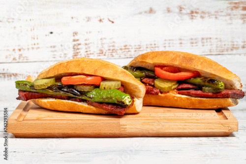 Sausage with bread on a wooden background. local name ekmek arasi sucuk