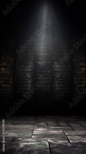 Dark empty room with stone walls and tiled floor illuminated by a single spotlight