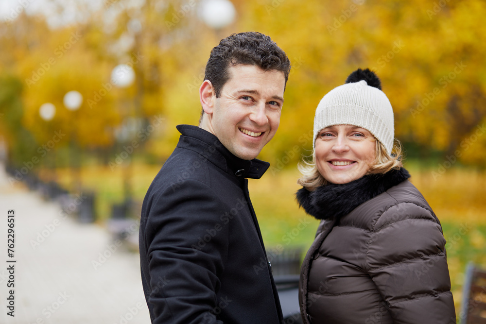 Half-length portrait of smiling man and woman in autumn park. Half-length portrait of smiling man and woman in autumn park.