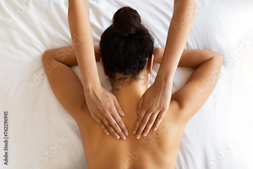 Above view woman receiving healing body massage at luxury spa