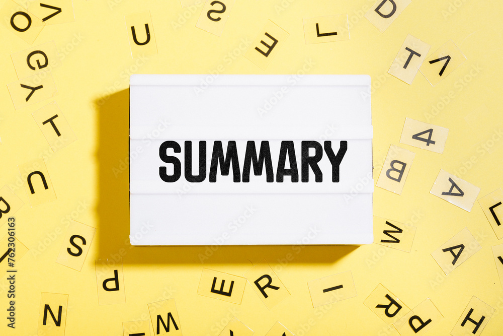 Summary word written in letters on lightbox with yellow background