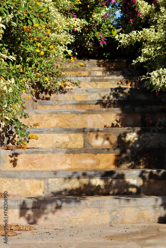 Natural stone steps stairs in the tropical garden. Summer vacation and coastal nature concept