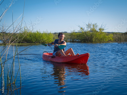 Front view of man in a kayak on a lagoon	
