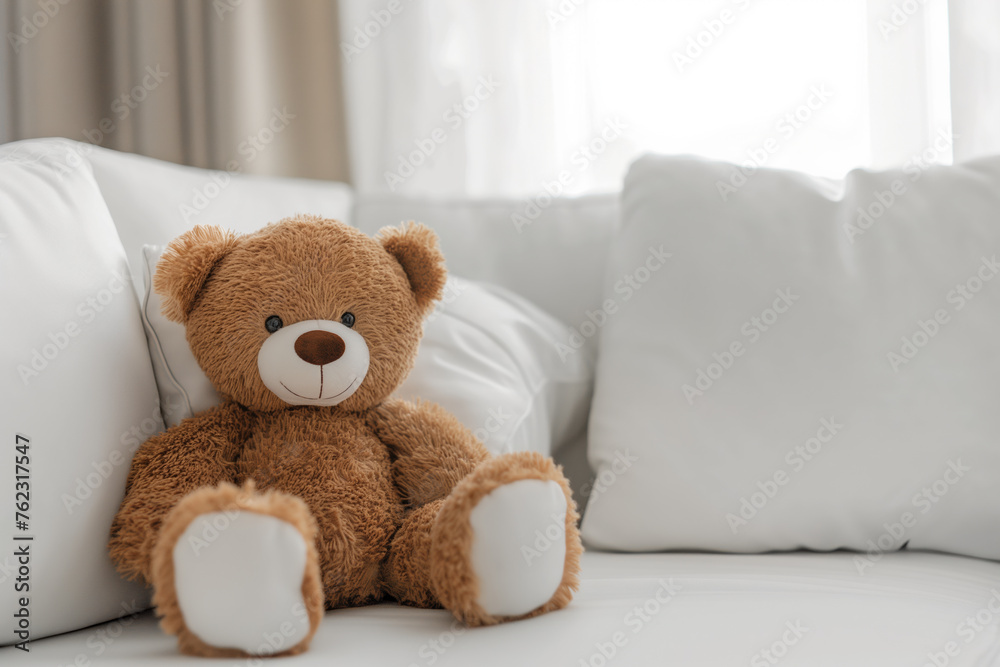 Cozy Comfort. Teddy Bear on a White Sofa in a Bright Living Room with Natural Light