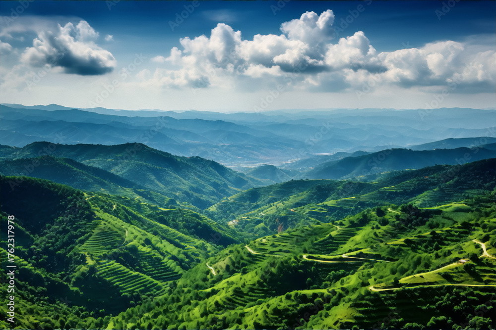 Fototapeta premium Green mountain ranges under blue sky and white clouds