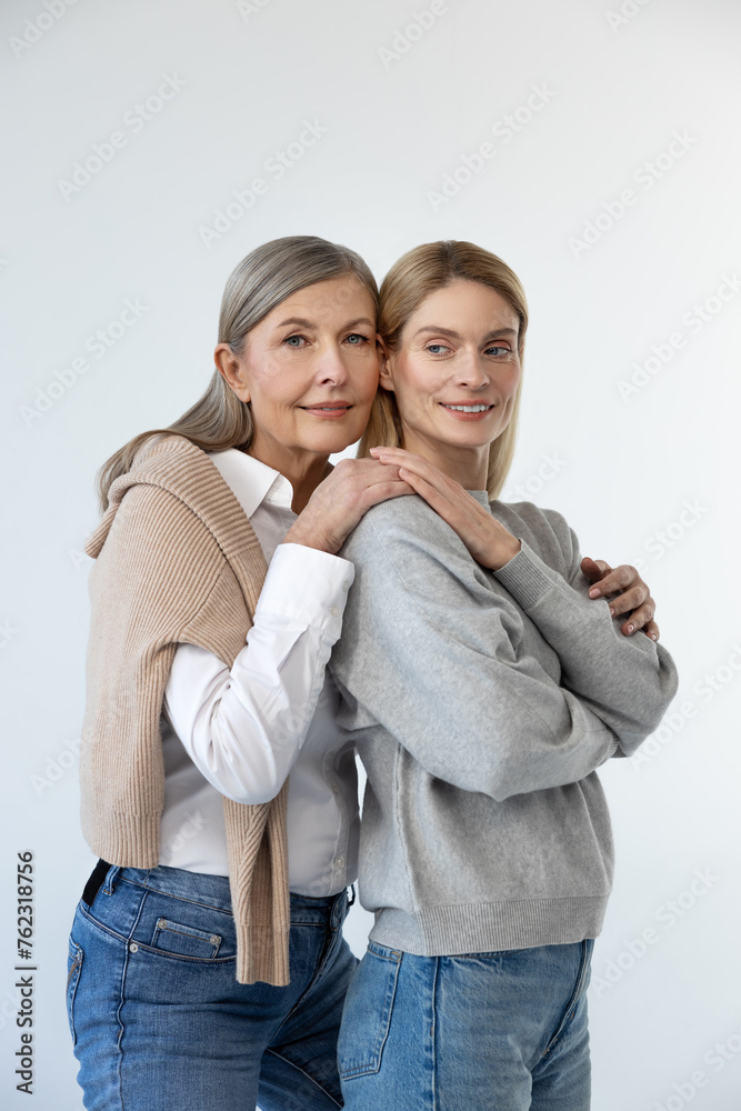 Mom and daughter standing close and looking peaceful Mom and daughter standing close and looking peaceful