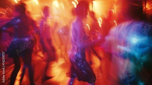 People dance in the blurred glow of club lights, immersing themselves in the vibrant nightlife of the party scene.