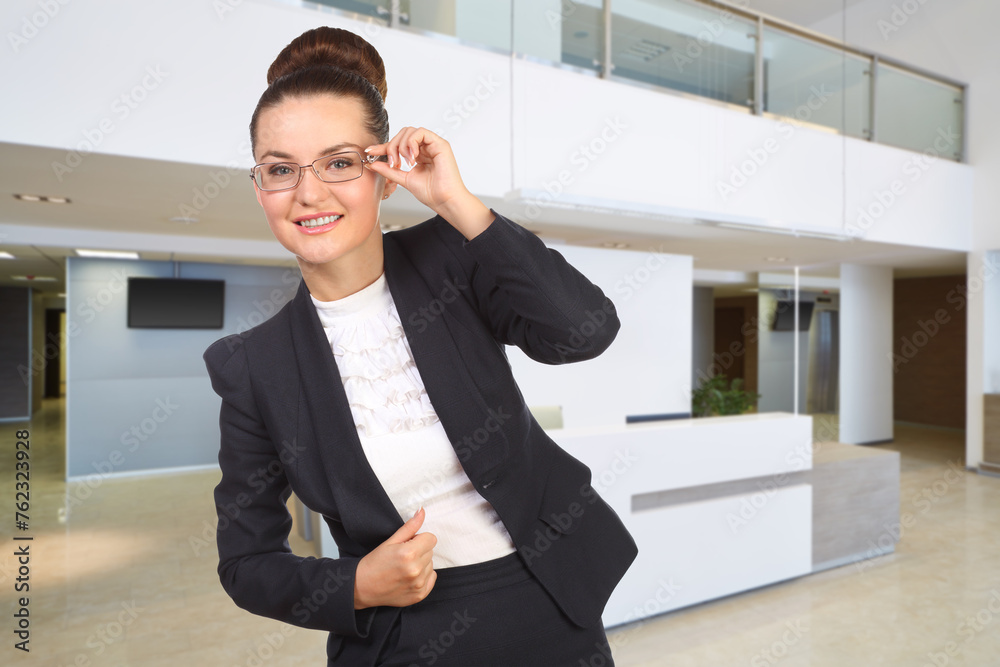 Businesswoman in glasses stabnds in reception hall of modern office building, collage Businesswoman in glasses stabnds in reception hall of modern office building, collage