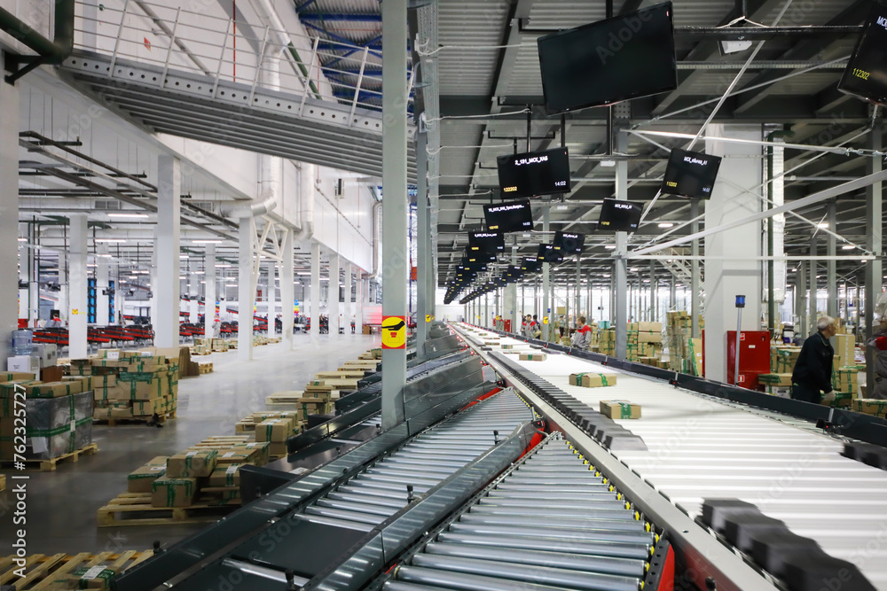 Fototapeta premium Working people in warehouse and sorting center of Ozon internet shop, it takes sixth place in list of most expensive russian internet companies