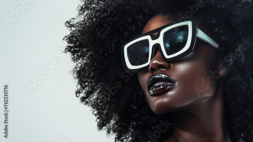 A fashion forward image showcasing a stylish woman with a voluminous afro and trendy sunglasses Focus on confidence and style