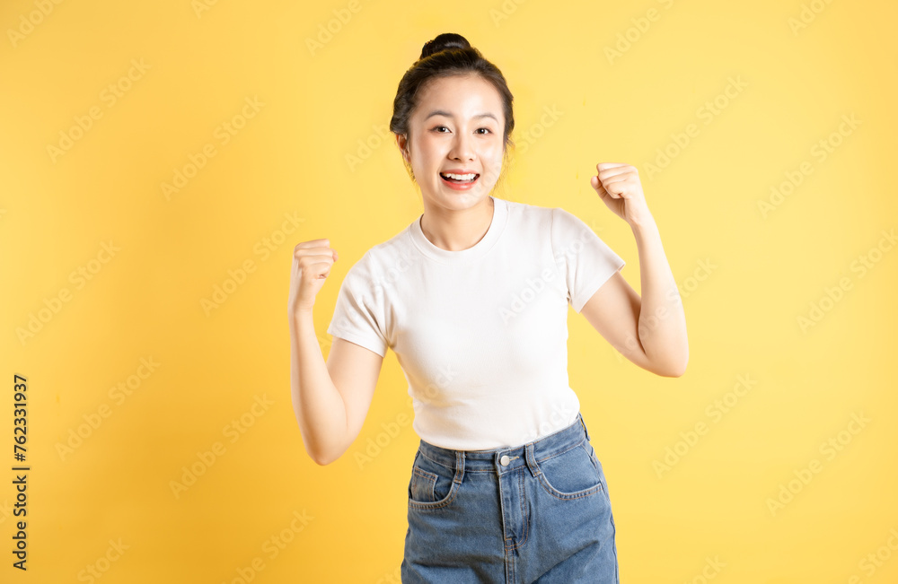 Portrait of Asian woman posing on yellow background Portrait of Asian woman posing on yellow background