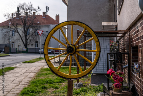 An old carriage wheel as a decoration next to the family house. A wonderful place in the middle of the village.