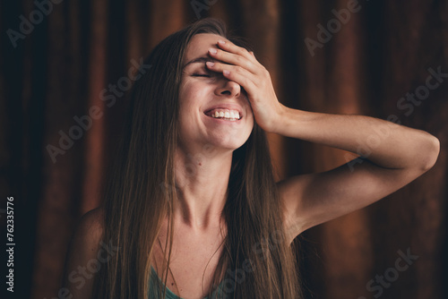 No filter natural photo imagery of attractive sensual girl with blond hairdo dressed underwear palm cover face laughing in dark studio