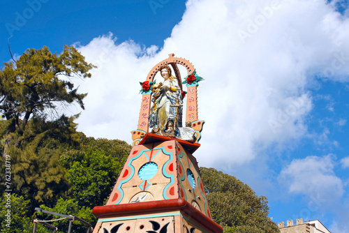 Wooden sculpture of Madonna Vasa Vasa on the bright sicilian cart in Palermo, Sicily, Italy