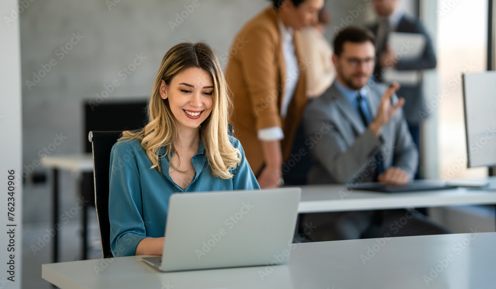 Successful businesswoman using laptop, working in office. Business technology corporate concept - obrazy, fototapety, plakaty 