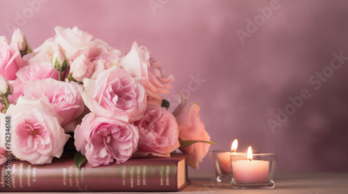 Pink roses and a book on a pink background