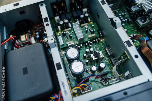 Canvastavla Close-up view of a powerful music amplifier circuit with large capacitors and capacitors, undergoing repairs to enhance sound quality