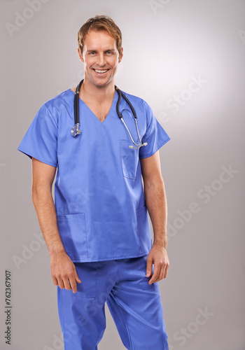 Man, nurse and portrait in studio, medical expert and specialist on gray background. Happy male person, cardiologist and proud of choice or decision on medicare, trustworthy physician and health © peopleimages.com