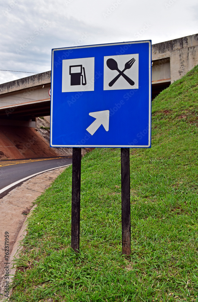 Traffic sign indicating the way to the gas station and restaurant in Ribeirao Preto, Sao Paulo, Brazil Traffic sign indicating the way to the gas station and restaurant in Ribeirao Preto, Sao Paulo, Brazil