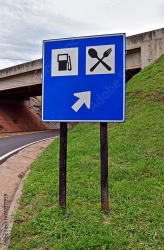 Traffic sign indicating the way to the gas station and restaurant in Ribeirao Preto, Sao Paulo, Brazil