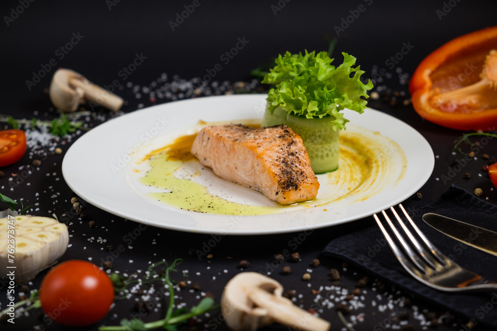 salmon in honey-soy glaze and fresh vegetable close-up on a plate. horizontal view from above