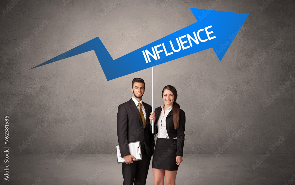 Fototapeta premium Young business person in casual holding road sign