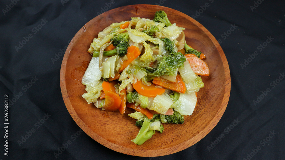 Fried capcay or cap cai or Hokkien is a mixture of vegetables stir-fried with chicken other dishes. Isolated on black background. Fried capcay or cap cai or Hokkien is a mixture of vegetables stir-fried with chicken other dishes. Isolated on black background.