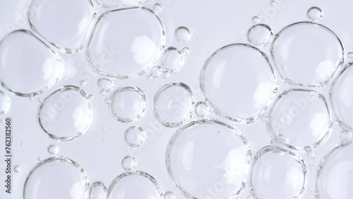 Motion of molecule bubbles in a cosmetic serum, macro. Transparent cosmetic gel fluid with molecule bubbles. Macro shot of natural organic cosmetics, health care , medicine. Slow Motion photo