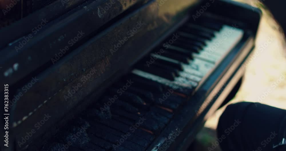 Man's hands play on burnt piano keys. A burnt piano. Man's hands on the piano. Man's hands play on burnt piano keys. A burnt piano. Man's hands on the piano.