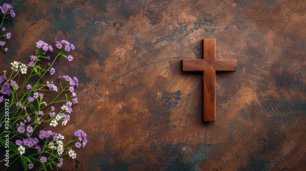wooden orthodox cross on a wooden background with purple and white flowers, empty space for text