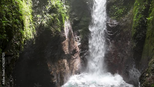 Maravillosa  caida de agua oculta entre las montañas, hermosas cascadas de aguas color turquesa llenas de vegetacion en la comarca Ngabe Bugle de panama. photo