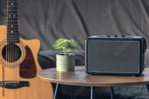 Close up, music speaker and acoustic guitar in the interior of the room.